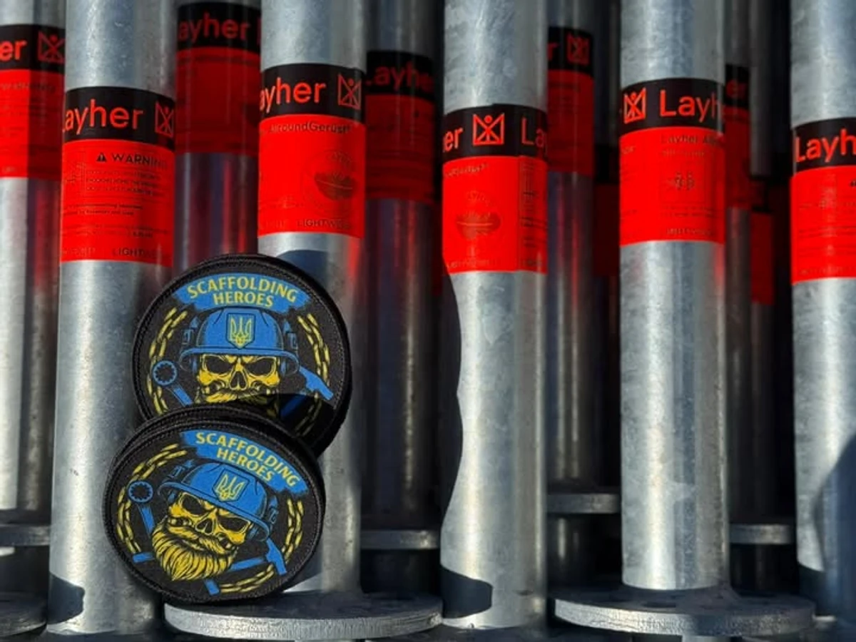 Риштування від Layher з емблемою партнерів Scaffolding Heroes